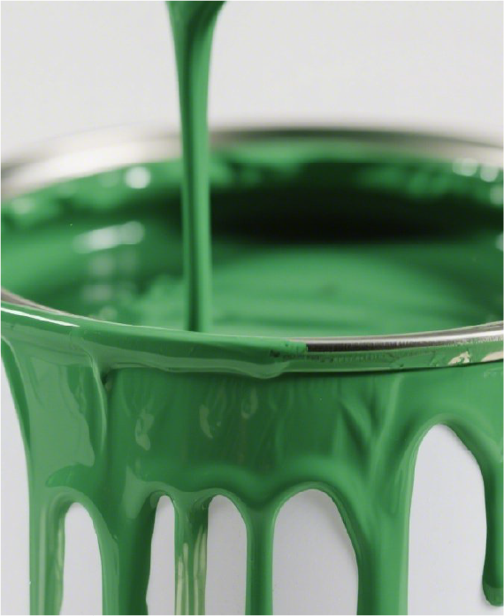 Green paint being poured into a metal can — industrial DBE applications